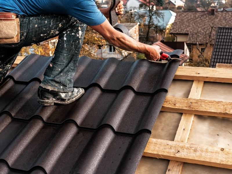 roofer close up installing metal roof at residential property bethleham pa